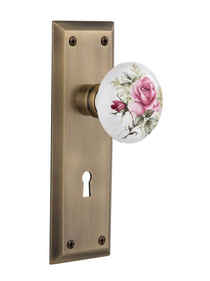 New York Plate with Rose Porcelain Knob with Keyhole in Antique Brass.